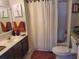 Bright bathroom featuring a shower-tub combo, vanity with sink, and neutral-toned decor at 2605 Gala S Rd, Kissimmee, FL 34746