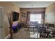 Cozy living room with stylish decor, modern lighting, neutral colored walls, and a large window at 2605 Gala S Rd, Kissimmee, FL 34746