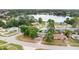 Scenic aerial view of lakeside neighborhood with mature trees and well-maintained homes on a sunny day at 995 Merrimac St, Deltona, FL 32725