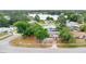 Aerial view of the house, showcasing the property's location and neighborhood with a lake in the background at 995 Merrimac St, Deltona, FL 32725