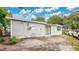 View of the backyard with a sliding glass door and a large yard at 995 Merrimac St, Deltona, FL 32725