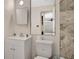Bathroom with a vanity, toilet, mirror, and partially tiled walls at 995 Merrimac St, Deltona, FL 32725