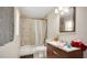 Full bathroom with tiled tub, mirror, and single vanity at 995 Merrimac St, Deltona, FL 32725