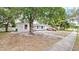 Street view of a single-story house with mature trees in the front yard at 995 Merrimac St, Deltona, FL 32725