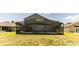 The backyard has a screened-in pool area and green lawn at 2433 Huron Cir, Kissimmee, FL 34746