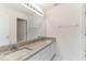 Bathroom vanity featuring granite counters and double sinks at 2433 Huron Cir, Kissimmee, FL 34746