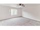 Spacious bedroom with neutral carpet, ceiling fan, and large window at 2433 Huron Cir, Kissimmee, FL 34746