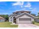 Charming two-story home with a two car garage and well-manicured lawn at 2433 Huron Cir, Kissimmee, FL 34746