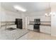 Spacious kitchen boasts white cabinets, granite counters, stainless steel appliances, and tile floors at 2433 Huron Cir, Kissimmee, FL 34746