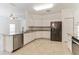 Open-concept kitchen features stainless steel appliances, granite countertops, and tile flooring at 2433 Huron Cir, Kissimmee, FL 34746