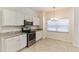 Bright kitchen with white cabinets, stainless steel appliances, and granite countertops at 2433 Huron Cir, Kissimmee, FL 34746