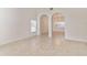 A bright and spacious living room featuring tile floors and arched entryways at 2433 Huron Cir, Kissimmee, FL 34746