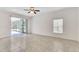 Open living room with tile flooring, sliding glass doors, and a window at 2433 Huron Cir, Kissimmee, FL 34746