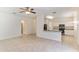 Open-concept living area with tile floors, and a kitchen with granite countertops at 2433 Huron Cir, Kissimmee, FL 34746