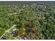 An aerial view with red boundary lines showcasing this property in a lush and treed neighborhood at 5434 Se 39Th Ave, Ocala, FL 34480