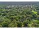 An aerial view shows the treed, lush neighborhood surroundings of this property, surrounded by greenery at 5434 Se 39Th Ave, Ocala, FL 34480
