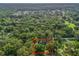 An aerial view with red boundary lines showcasing the treed, lush, neighborhood surroundings of this home at 5434 Se 39Th Ave, Ocala, FL 34480