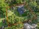 An aerial view of the property with red boundary lines, showcasing mature trees and a large backyard at 5434 Se 39Th Ave, Ocala, FL 34480