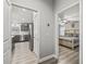 View into bedroom and kitchen from a hallway with gray walls and wood flooring at 5434 Se 39Th Ave, Ocala, FL 34480