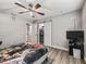 This bedroom features a ceiling fan and a closet with sliding barn doors at 5434 Se 39Th Ave, Ocala, FL 34480
