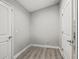 An empty room features light gray walls, wood flooring, and two white doors at 5434 Se 39Th Ave, Ocala, FL 34480