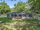 Charming single-story home featuring a well-manicured lawn and a rustic wooden fence at 5434 Se 39Th Ave, Ocala, FL 34480