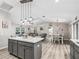 Open concept kitchen and dining area with stainless steel appliances, kitchen island and wood flooring at 5434 Se 39Th Ave, Ocala, FL 34480