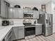 Kitchen with gray cabinets, stainless steel appliances, and quartz countertops at 5434 Se 39Th Ave, Ocala, FL 34480