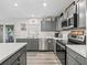 Kitchen featuring gray cabinets, stainless steel appliances, and white subway tile backsplash at 5434 Se 39Th Ave, Ocala, FL 34480