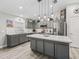 A kitchen with gray cabinets, an island, stainless steel appliances, and quartz countertops at 5434 Se 39Th Ave, Ocala, FL 34480