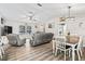An open-concept living area with a dining space, comfy seating, and bright, neutral decor at 5434 Se 39Th Ave, Ocala, FL 34480