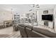 Open-concept living area showcasing comfortable seating, a modern ceiling fan, and bright, neutral decor at 5434 Se 39Th Ave, Ocala, FL 34480