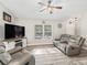 A cozy living room featuring comfortable leather seating and a large window at 5434 Se 39Th Ave, Ocala, FL 34480