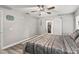 Well-lit bedroom with barn door leading to the closet, featuring wood flooring and a ceiling fan at 5434 Se 39Th Ave, Ocala, FL 34480