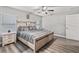 A bright bedroom with a light wood frame bed, ceiling fan, and matching nightstands at 5434 Se 39Th Ave, Ocala, FL 34480