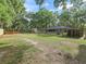Expansive fenced yard featuring lush greenery, trees, and outbuildings, creating a serene and functional outdoor space at 5434 Se 39Th Ave, Ocala, FL 34480
