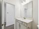 Bathroom features a gray vanity, large mirror and modern fixtures at 5944 Bristle Oak St, Mount Dora, FL 32757