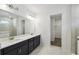 Bathroom with double sink vanity, white quartz countertops, and large mirror at 5944 Bristle Oak St, Mount Dora, FL 32757