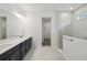 Bathroom features double vanity, white quartz counters, and glass shower at 5944 Bristle Oak St, Mount Dora, FL 32757