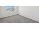 Bright bedroom featuring neutral carpet and sunny view at 5944 Bristle Oak St, Mount Dora, FL 32757