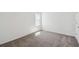 Bright bedroom features plush carpeting and a sunlit window at 5944 Bristle Oak St, Mount Dora, FL 32757