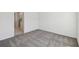 Neutral carpet and white walls in this bedroom lead to ensuite bath at 5944 Bristle Oak St, Mount Dora, FL 32757