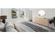 Bright bedroom with natural light, neutral tones, dresser and windows at 5944 Bristle Oak St, Mount Dora, FL 32757