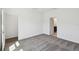 Cozy bedroom with soft carpet and white trim features a doorway to bathroom at 5944 Bristle Oak St, Mount Dora, FL 32757