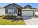 Charming single-story home featuring a two-car garage and a welcoming front yard with stylish landscaping at 5944 Bristle Oak St, Mount Dora, FL 32757