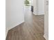 An entryway hallway featuring clean, modern design elements and beautiful wood-style flooring at 5944 Bristle Oak St, Mount Dora, FL 32757