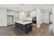 Spacious kitchen featuring a large island with counter seating, modern appliances, and ample cabinet space at 5944 Bristle Oak St, Mount Dora, FL 32757