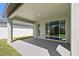 Covered back patio area with sliding glass doors at 5944 Bristle Oak St, Mount Dora, FL 32757