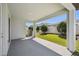 A covered back patio overlooks a grassy yard and landscaping at 5944 Bristle Oak St, Mount Dora, FL 32757