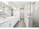 Bathroom featuring double sinks with quartz countertops and a walk-in tiled shower at 6087 Sacred Oak Ave, Mount Dora, FL 32757